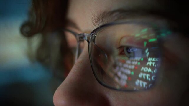 A young trader girl intently tracks real-time stock market fluctuations, her glasses reflecting the changing numbers on the screen, as she analyzes market trends with focus and precision