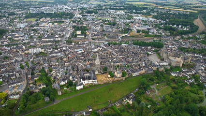 Obraz premium Aerial view beside the old town above the city Vitré in France, on a cloudy noon in early summer.