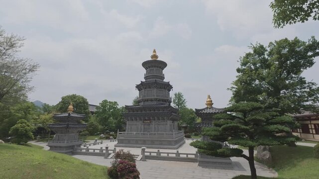 4K resolution panning right shot of the traditional ancient Chinese stone pagoda tower and pine tree at Donglin Temple scenic area in Jiujiang, shot in ProRes Log format