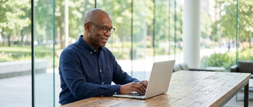 Older African latin note executive corporate investment old laptop senior ceo business mature businessman man age manage tech manager technology finance office adult male investor banker job company