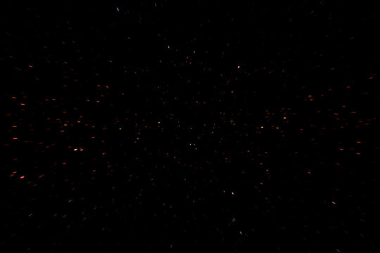 Particules beiges sur fond noir avec effet visuel de vitesse color&eacute; multicolore