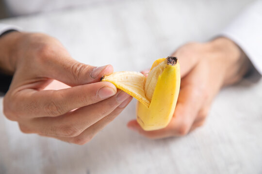 Doctor holding a banana. Health. Calories. Food