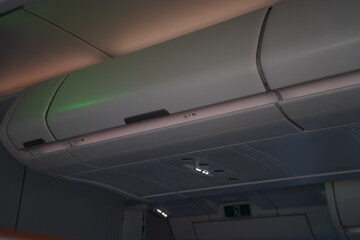 Fototapeta premium Overhead Luggage Compartment Inside Commercial Airplane Cabin