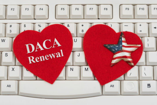 DACA Renewal text on red hearts with American flag star on a white computer keyboard for application