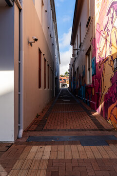 Brick paved lane way featuring street art. Armidale, New South Wales, Australia 