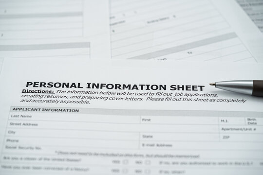 Close up of personal information sheet with pen on application form.