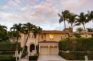 Fototapeta premium Suburb private exterior with palm tree. Suburban neighborhood. Private family cottage architecture. House exterior. Summer cottage. Private house in suburban area. Suburban house architecture