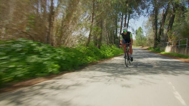 Athletic man riding a road bike. Sports and long distance cycling. Healthy lifestyle.