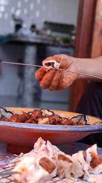 Threading boulfaf liver wrapped in caul fat on Moroccan skewer