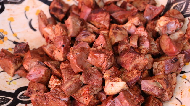 Threading boulfaf liver wrapped in caul fat on Moroccan skewer