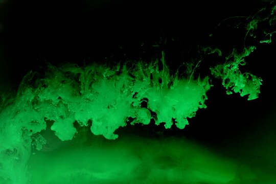 Green colorful dye on black background,Art abstract smoke texture,Colored liquid dye,Splash paint,Abstract color,Abstract Textures
