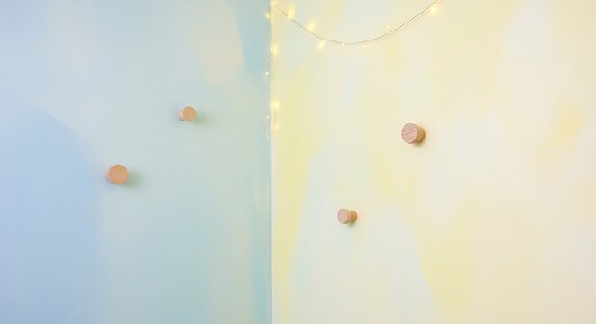 Pastel Wall with Wooden Pegs and Warm String Lights in Minimal Interior