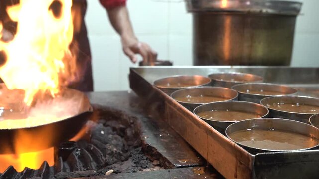 Close up shot of preparing Dal Makhani in traditional Indian dhaba kitchen.