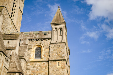 Fototapeta premium Christ Church Cathedral stone towers under a blue sky in Dublin, Ireland