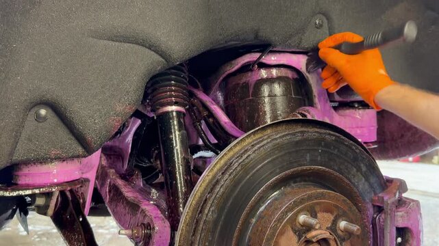 The process of washing the suspension, the underbody of the car with a chemical composition and a brush at the car wash. Washing the suspension of the car from reagents and contaminants using special 