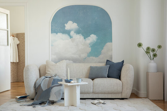 Cozy Living Room Interior with Cloud Mural and Minimalist Decor, Warm and Inviting Home Space Design