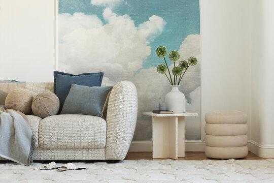 Cozy Living Room Corner with Sofa, Decorative Elements, and Cloud-Themed Wall Art for Home Interior Design
