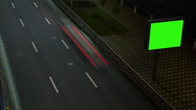 Timelapse of car movement at night, fast moving lights, advertising banner with green background