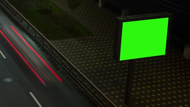 Timelapse of car traffic on a highway at night, fast moving lights, advertising banner with green background