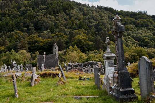 Ancient Celtic crosses and gravestones at Glendalough monastic site, Ireland