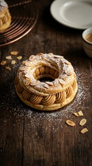 Fototapeta premium Paris-Brest pastry with praline cream and almonds on dark wood