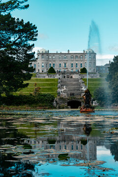 Powerscourt House and gardens with lake reflection in Wicklow, Ireland.