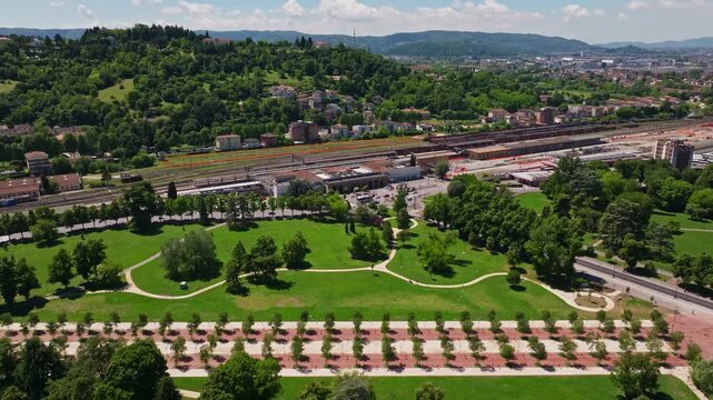 Aerial drone view of Campo Marzo Park in Vicenza, Italy, featuring expansive green spaces, tree-lined pathways, recreational areas, and the surrounding urban landscape