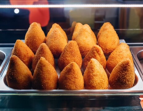 coxinhas already prepared in the glass display case of a bar in brazil