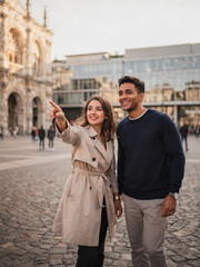 Fototapeta premium Happy Young Couple Sightseeing in a European City Square with Historic Architecture