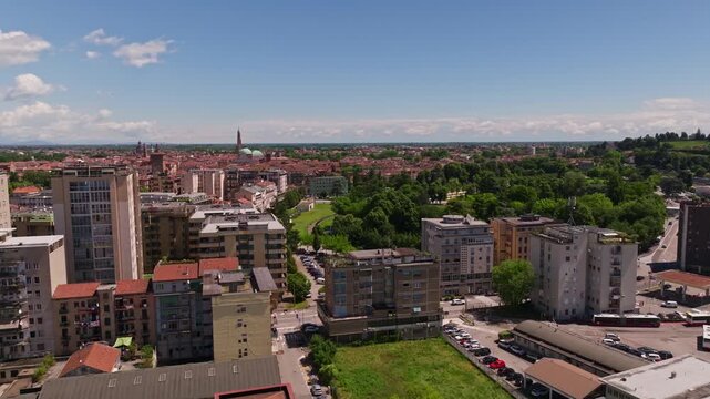 Aerial drone view of Campo Marzo Park in Vicenza, Italy, featuring expansive green spaces, tree-lined pathways, recreational areas, and the surrounding urban landscape