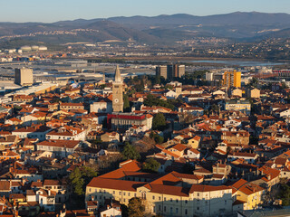 Obraz premium View of Koper, Slovenia, featuring the waterfront, marina, and cityscape under clear sky.