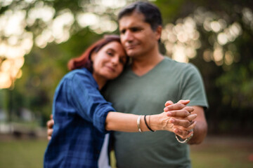 Fototapeta premium Couple embracing in peaceful park.