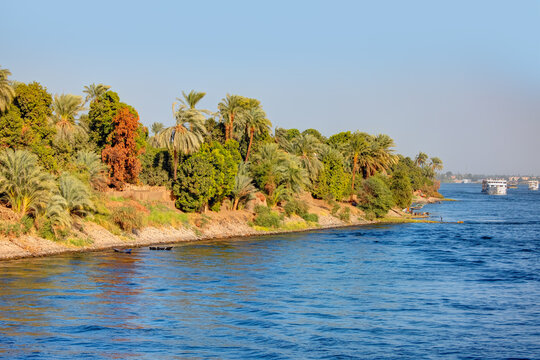 Beautiful Nile scenery with traditional Felluca sailing boat in the Nile - Aswan, Egypt