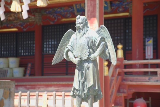Tengu statue in spring sunlight at Yakuoin Temple on Mount Takao