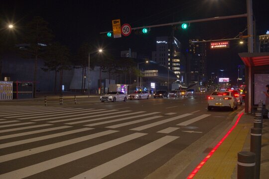 Vibrant night traffic flowing past futuristic Dongdaemun in Seoul.