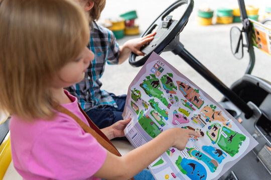Children exploring zoo map adventure.