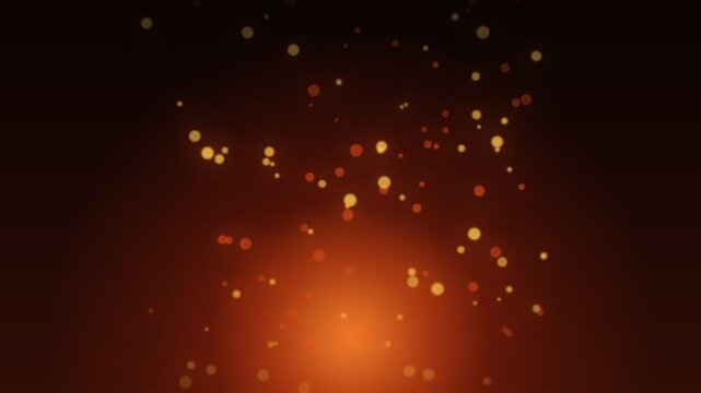 Warm golden particles rising from a bright orange light source