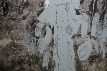 Concrete wall with cracked texture and grey paint repairs © Firman