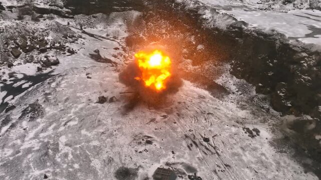A powerful detonation striking an abandoned armored tank in a snow covered quarry which creates a large fireball and intense debris cloud during a cold winter day