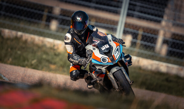 Regular training in Riga, Latvia,  Bikernieki on 12-05-2026  Motorcyclist racing around a dirt track at sunset