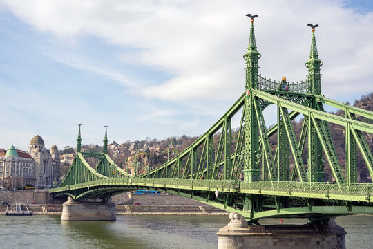 Hungary, Budapest- 2023 March 10. Beautiful Liberty Bridge at sunrise with cherry blossom around. Spring has arrived in Budapest.