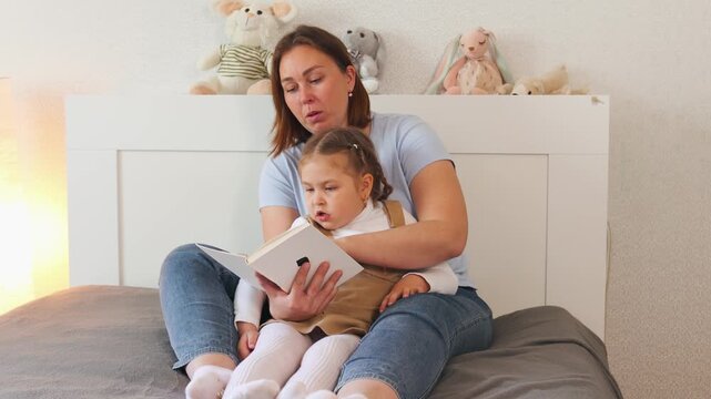 Child and adult share a quiet reading moment. Learning through books and nurturing preschool development. Mid shot