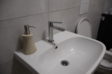 Fototapeta premium Bathroom Washbasin with Liquid Soap Dispenser and Faucet