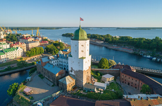 Vyborg Castle and Saint Olaf Tower stand proudly on an island, overlooking the city and Vyborg Bay in Russia during a bright sunny day