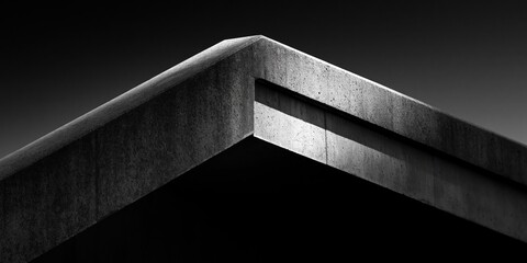 Naklejka premium A striking close-up of a concrete corner in architectural design, emphasizing sharp lines and modern aesthetics, showcasing contemporary industrial style.
