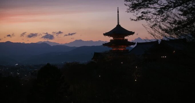 Majestic silhouette of beautiful, ancient Japanese temple at dusk