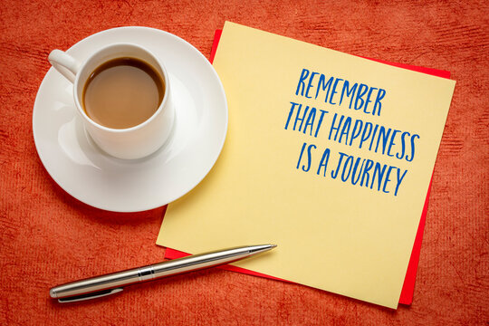 Remember that happiness is a journey - inspirarional reminder note with coffee.