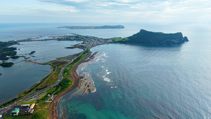Aerial drone view of Seongsan Ilchulbong coastal village farmland and ocean landscape in Jeju Island South Korea © 은수 조