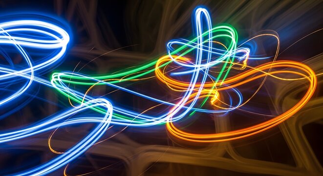 Light trails create vibrant neon streaks against a dark background in this abstract long exposure.