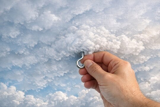 A close-up of a hand holding a ring in the snow, possibly a proposal or romantic moment